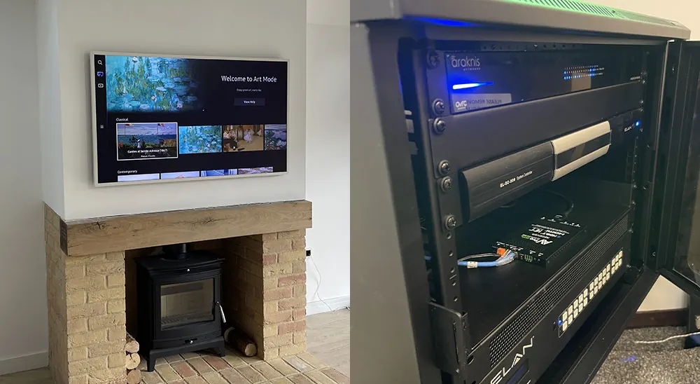 TV mounted above a log burner, next to an AV equipment rack with neatly installed components